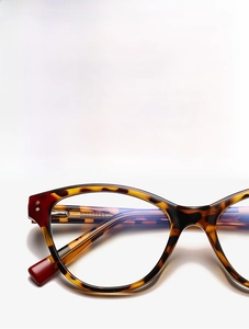 Detail of tortoise shell texture and premium metal hinges on stylish retro eyeglass frames