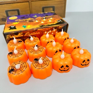 Set of 12 Halloween orange pumpkin LED candles with spider web and smiling face patterns