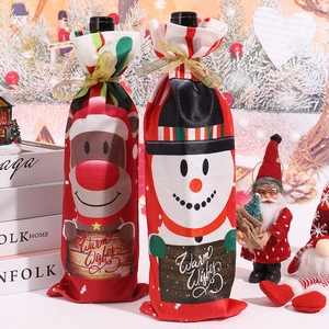 Close-up of Christmas wine bottle covers with reindeer and snowman on a festive table