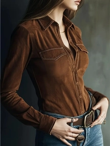 Detail of brown faux suede shirt showing collar, chest pockets and stitching texture