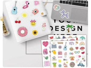 Detail of assorted cute waterproof vinyl stickers on laptop and leather notebook
