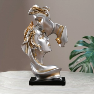 Modern resin couple kissing sculpture with silver and gold metallic finish on a black base