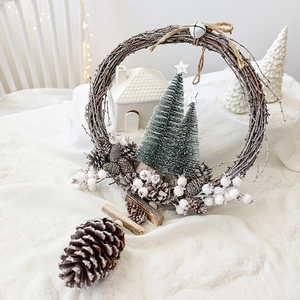 Nordic Christmas pine cone wreath with flocked trees and bells on white background