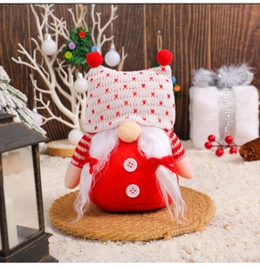 Detail of Christmas gnome plush with red knit hat, white beard, and festive decor