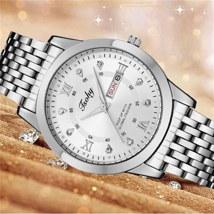 Detail of silver business watch featuring a white dial with Roman numerals and day-date display