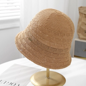 Stylish breathable hollow knit bucket hat for women featuring a metal tag detail