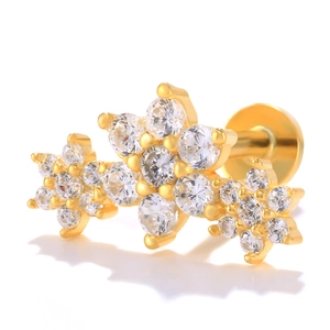 Macro shot of gold flower labret stud with sparkling clear zircon stones and flat back