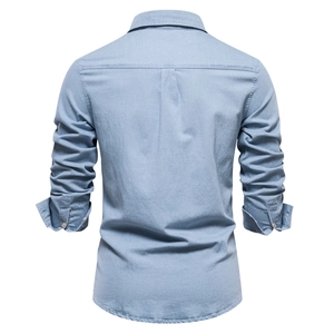 Rear view of light blue denim shirt showing the back yoke and tailored slim fit silhouette
