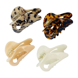 Set of four tortoiseshell and solid color acetate moon hair claws with durable metal springs