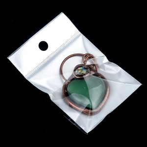 Vintage heart pendant with tiger eye stone and bronze frame in clear packaging
