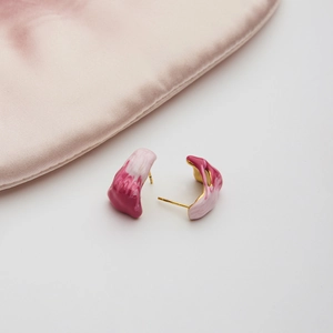 Detail of pink marble effect enamel earrings with 18K gold-plated stainless steel base