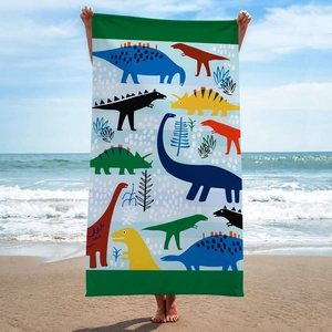 Microfiber beach towel featuring a colorful dinosaur cartoon print on a sunny beach setting