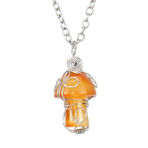 Detailed close-up of handmade wire-wrapped orange mushroom crystal pendant on a silver chain