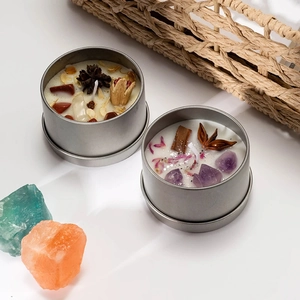 Macro detail of scented candle with natural crystals and dried flowers in a silver tin