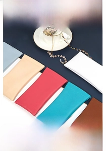 Close-up of colorful leather eyewear pouches with fine stitching and soft texture