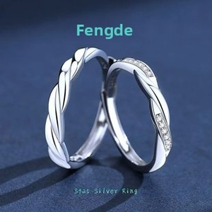 Close-up of S925 sterling silver couple rings with Mobius twist and pavé zircon stones