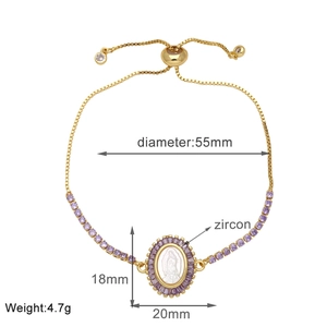 Detail of adjustable gold bracelet with Virgin Mary pendant and purple zircon stones