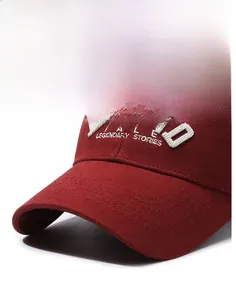 Close-up of legendary stories white embroidery on burgundy cotton baseball cap