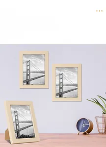 Detail of light wood grain photo frame with desktop stand and Golden Gate Bridge art