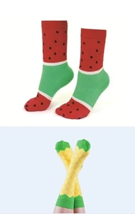 Detail view of cotton socks with creative watermelon and pineapple fruit patterns