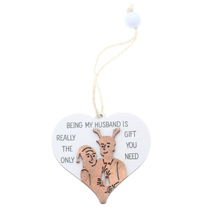 Detail of heart-shaped wooden plaque with 'Being My Husband' quote and carved couple design