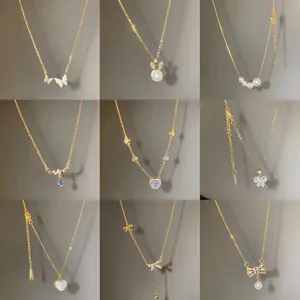 Nine elegant gold titanium necklaces with butterfly, pearl and crystal pendants