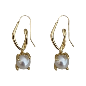 Minimalist gold-tone curved earrings with white pearl detail on a white background