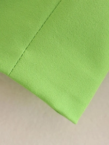 Close-up of grass green twill fabric showing high-quality stitching and textile density