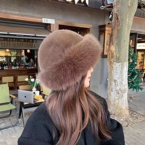 Close-up of plush dark brown faux fur hat showing fluffy texture and warm winter material