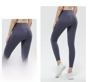 Macro detail of high-waist peach lift seams on matte blue-grey compression yoga leggings