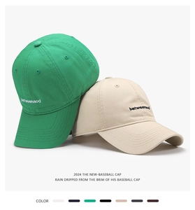Detail of embroidered cotton baseball caps in multiple colors showing stitching and fabric