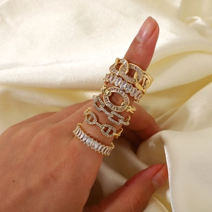 Set of six gold vintage zircon rings for women on silk background in a main view