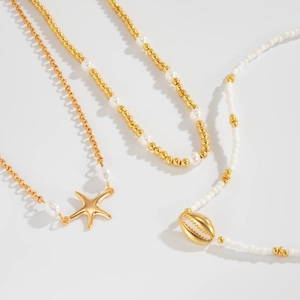 Detail view of Bohemian sun flower layered necklace with shell and starfish pendants