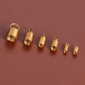 Detailed view of golden stainless steel spring coil connectors for jewelry making