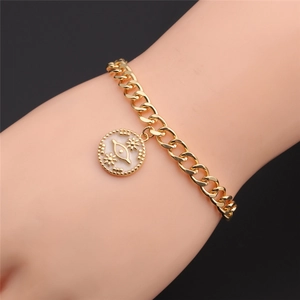 Detail of 14k gold plated evil eye bracelet with white enamel and zircon star charm