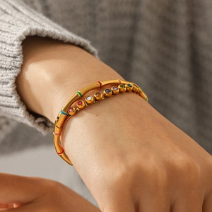 18K gold bamboo stainless steel bracelet with colorful enamel zircon gemstones on a wrist