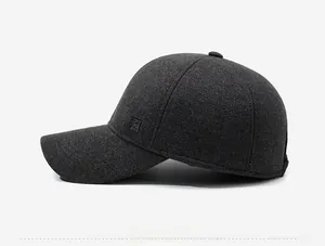 Close-up of charcoal grey wool baseball cap with thermal lining and side metal logo