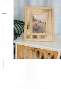Detail of Nordic solid wood frame with intricate rattan weaving on white cabinet with plants