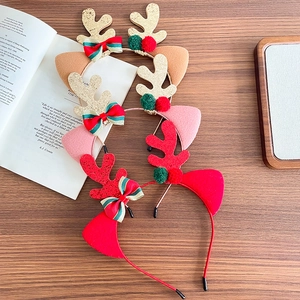 Festive Christmas antler headbands for girls with sequins and bows on a warm wooden background