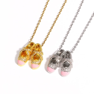 Detailed view of pink ballet slipper necklaces with sparkling rhinestones in gold and silver