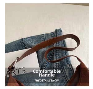 Detail view of brown suede tote bag with silver hardware and leather shoulder strap