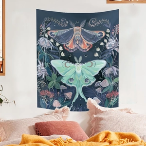 Bohemian moth tapestry with moon and flowers hanging on a white bedroom wall