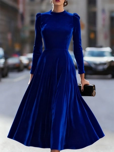 Close-up of royal blue velvet midi dress featuring a tall collar and elegant long sleeves