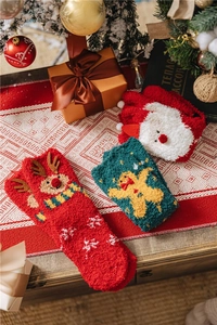 Cozy coral fleece Christmas socks featuring festive reindeer and Santa Claus designs