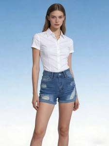 Detail of blue denim shorts with distressed ripped texture and cuffed hem for summer