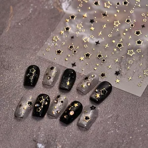 Macro view of M-967 nail art stickers with gold and black star patterns and sample tips