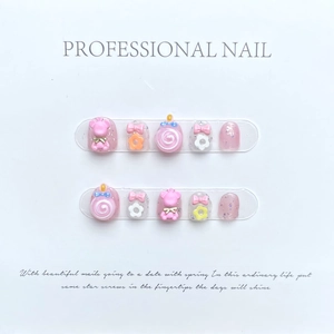 Handmade pink press-on nails for kids featuring 3D bears, lollipops, and bow designs