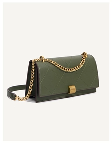 Close-up of emerald green quilted crossbody bag with gold chain and metal clasp