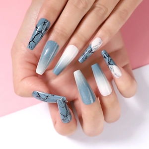 Close-up of long coffin-style Halloween fake nails with blue marble and glitter gradient design