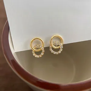 Elegant gold intertwining hoop earrings with sparkling micro-paved cubic zirconia stones